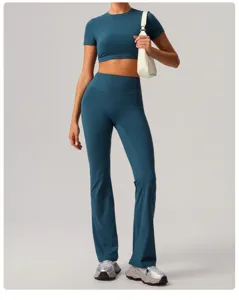 Women's quick-dry crop top and flared yoga pants set in dark blue for fitness workout.
