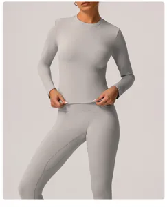 Women's solid light gray long sleeve athletic top paired with high waist yoga pants set.
