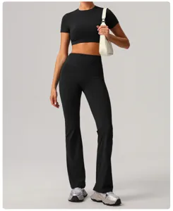 Detailed view of women black athletic crop top and high-waist flare yoga pants activewear set.