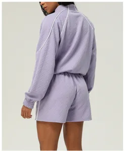 Detailed back view of the light purple textured athletic jacket and shorts set, showing stitching.
