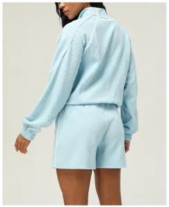 Light blue textured athletic jacket and shorts set, showing back design and white piping.