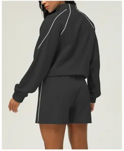Textured athletic two-piece set featuring long sleeve zip jacket and matching shorts.