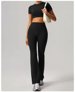 Black crop top and high-waisted flared yoga pants set, comfortable stretch fitness outfit.