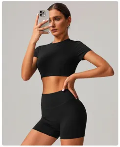 Detail shot of black athletic crop top and high waist yoga shorts set for women activewear.