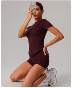 Close-up view of the slim-fit short sleeve athletic top and matching shorts in dark red.