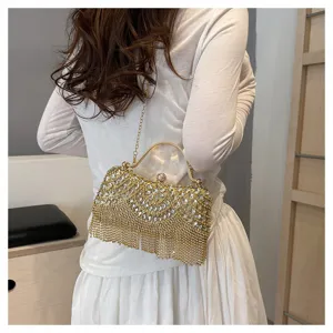 Close-up of golden rhinestone evening bag with luxury crystal tassels