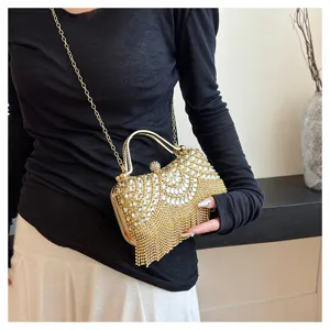 Detail view of luxury rhinestone evening bag with gold tassel fringes
