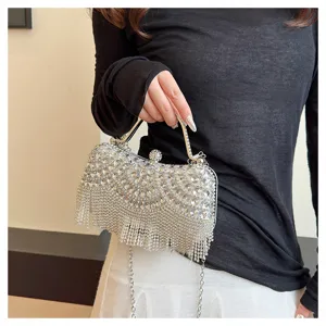 Detailed shot of sparkling silver rhinestone evening clutch bag with elegant fringe tassels