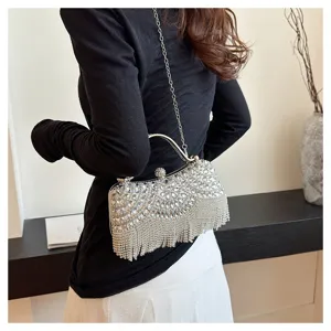 Close-up of elegant silver rhinestone evening bag with chain strap and tassels