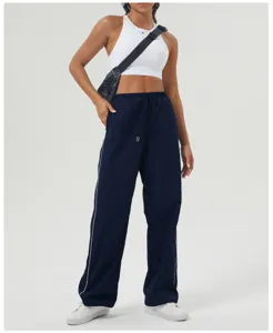 Close-up detail of navy blue casual cargo pants featuring white side piping and drawstring waist.