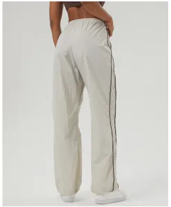 Detailed rear view of casual contrast piping cargo pants with drawstring waist and loose fit.