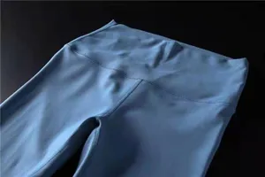 Close-up detail of light blue high-waisted brushed yoga leggings fabric texture