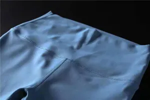 Close-up detail of light blue high-waist brushed yoga leggings showing waistband stitching.