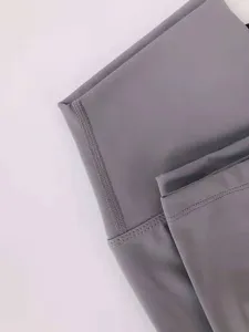 High-waist yoga pants fabric detail close-up, soft brushed texture and clean stitching.