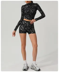 Detailed view of the metallic silver foil print activewear crop top and shorts set.