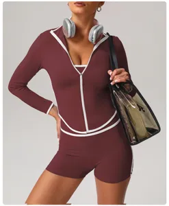 Women maroon long sleeve athletic zip top and shorts matching activewear set detail view.