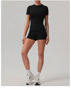 Detailed shot showing the slim-fit black sports short sleeve top and matching shorts.