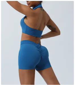 Back view detail of blue halter sports bra and scrunch butt yoga shorts set for fitness workout.