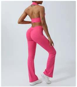 Women pink halter crop top flared yoga pants activewear fitness two piece suit detail.