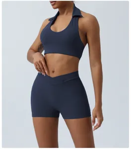 Women athletic yoga crop top and crossover shorts set, dark blue gym fitness wear.