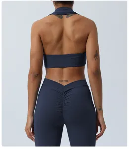 Back detail view of dark blue halter yoga top and scrunch butt fitness leggings set.