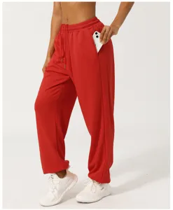 Detail shot of women casual high-waisted red sweatpants with convenient side pockets.