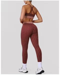 Back view of a brown polka dot two piece yoga set with high waist leggings and sports bra.
