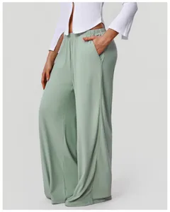 Detailed close-up of high-waist draped wide-leg lounge pants showing side pockets.