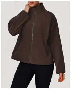 Detail view of the soft brown fleece zip-up jacket featuring a cozy stand collar and pockets.