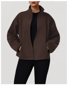 Close-up detail of women's brown fleece zip-up jacket featuring stand collar and cozy pockets.