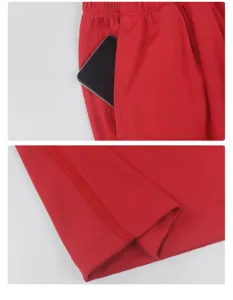Detailed close-up view of red sports trousers pocket and hem stitching craftsmanship.