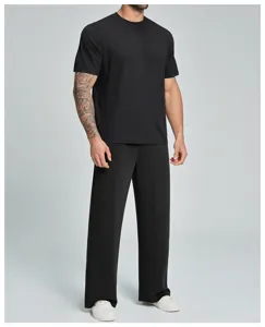 Men's athletic short sleeve t-shirt and pants detail view showcasing breathable fabric and fit.
