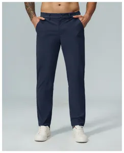 Detail view of men's casual straight quick-dry golf trousers in dark blue worn by a model.