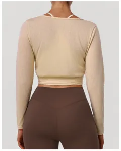Detailed back view of women long sleeve crop cover up top and slim yoga leggings set.