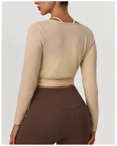 Back view detail of women slim long sleeve shrug top with camisole and brown yoga leggings.