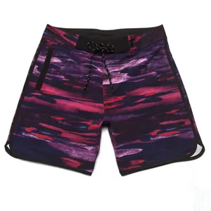 Detailed close-up of men's quick-dry board shorts featuring abstract print and black trim.