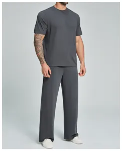 Detail view of men's breathable athletic t-shirt and pants set for workout and casual wear.