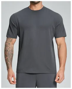 Close-up detail of a dark grey men's crew neck short sleeve sports t-shirt, breathable fabric.
