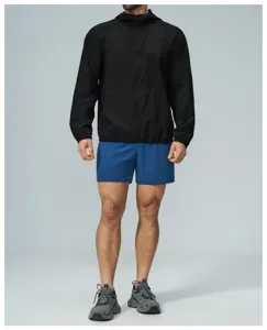 Detail view of men's outdoor sports hooded zip jacket and shorts, breathable athletic wear.