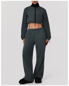 Detailed view of women's dark grey fleece crop jacket and matching wide leg sweatpants set.