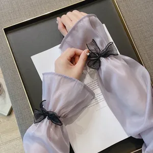 Manches de protection solaire translucides pour femmes avec nœuds noirs élégants, chic.