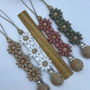 Silicone flower pacifier clip with wooden beads, baby teether soothing toy accessory detail.