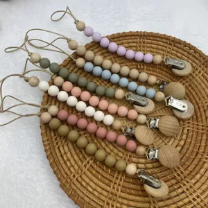 Silicone wooden bead pacifier chain detail shot, featuring multiple soft colors and secure clip.