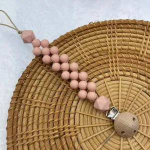 Detailed view of the silicone beaded baby pacifier clip with secure metal clasp chain.