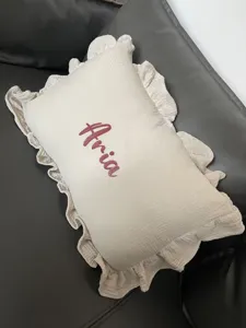 Children muslin ruffle rectangular throw pillow with custom name Aria for bedroom decor.