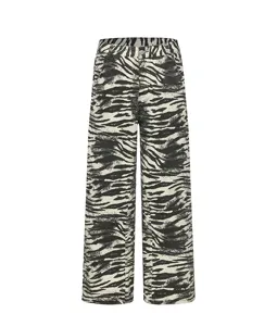 Detailed view of black and white zebra print baggy denim jeans, streetwear style texture.