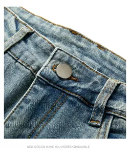 Men's vintage washed denim jeans waist close-up, button and contrast stitching detail