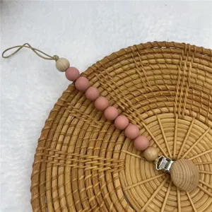 Silicone wooden baby pacifier clip teething chain detail view, safe secure infant soothing accessory