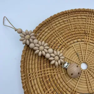 Silicone daisy flower pacifier clip with wooden beads and secure metal clasp for babies.