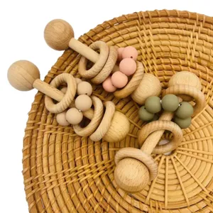 Handmade wooden and silicone baby rattle toy with natural beads and safe chewable teething rings.